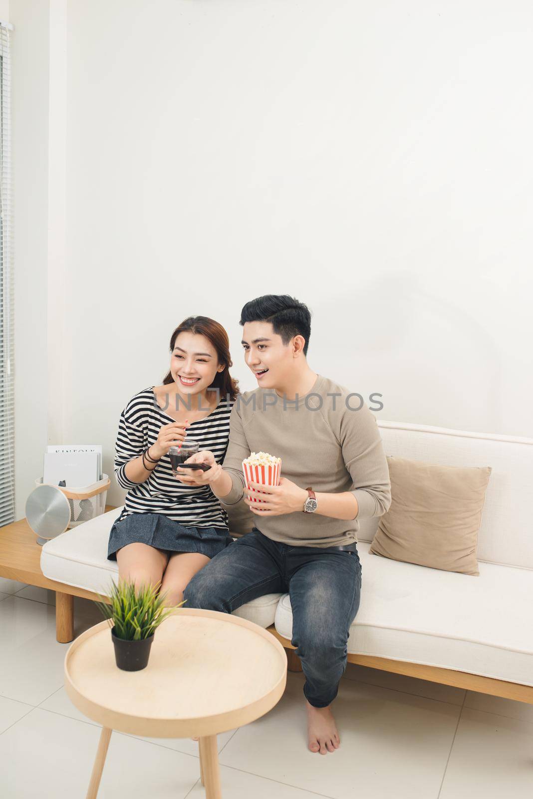 Young asian couple payment online using laptop buying movie ticket