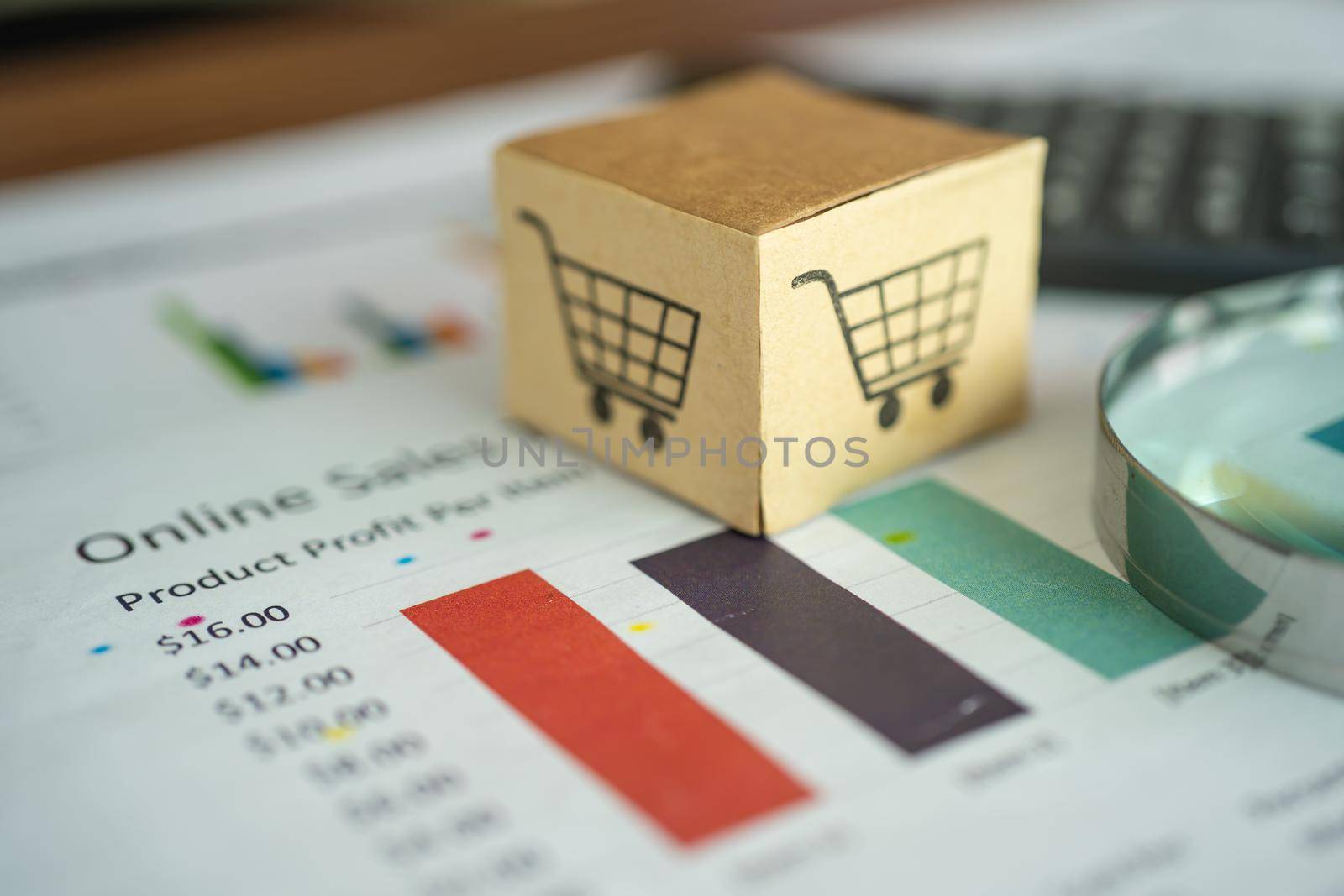 Shopping cart logo on box with magnifying glass on graph background. Banking Account, Investment Analytic research data economy, trading, Business import export transportation online company concept. by pamai