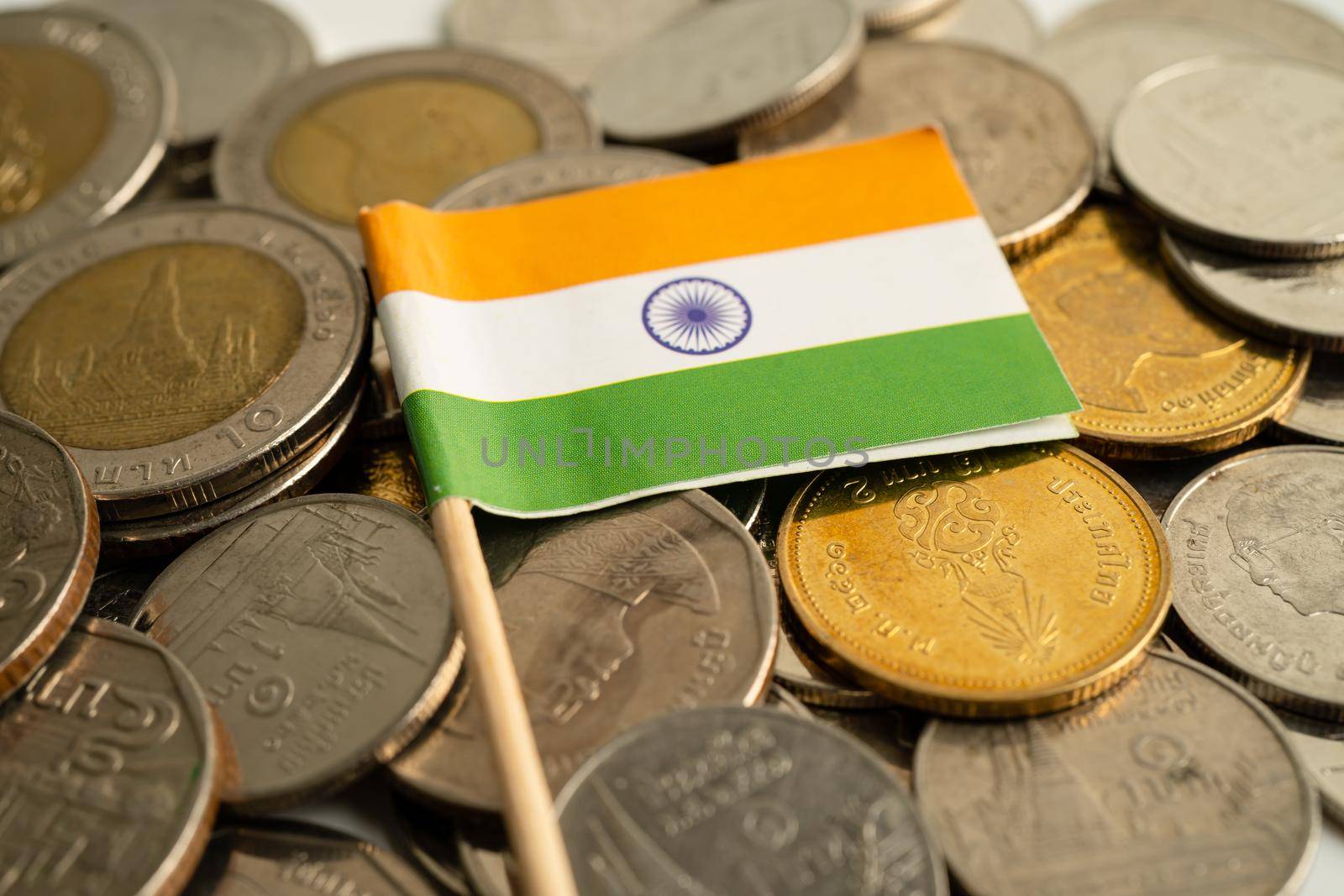 Stack of coins with India flag on white background. flag on white background. by pamai