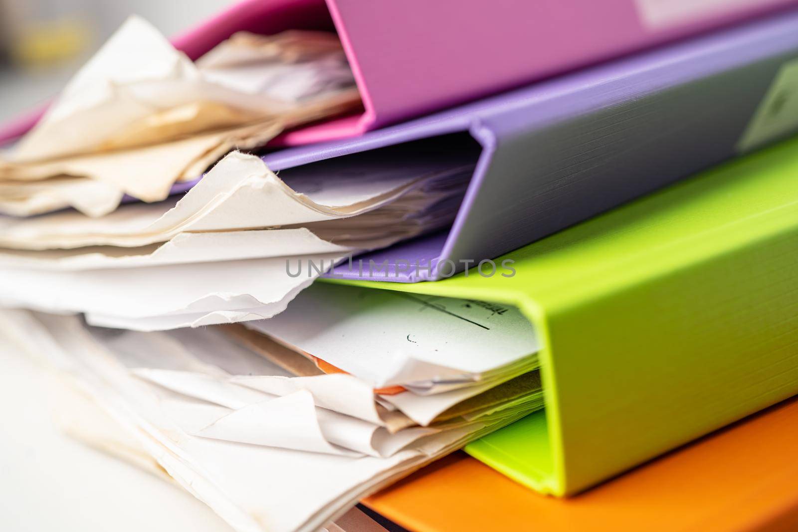 File Folder Binder stack of multi color on table in office. by pamai