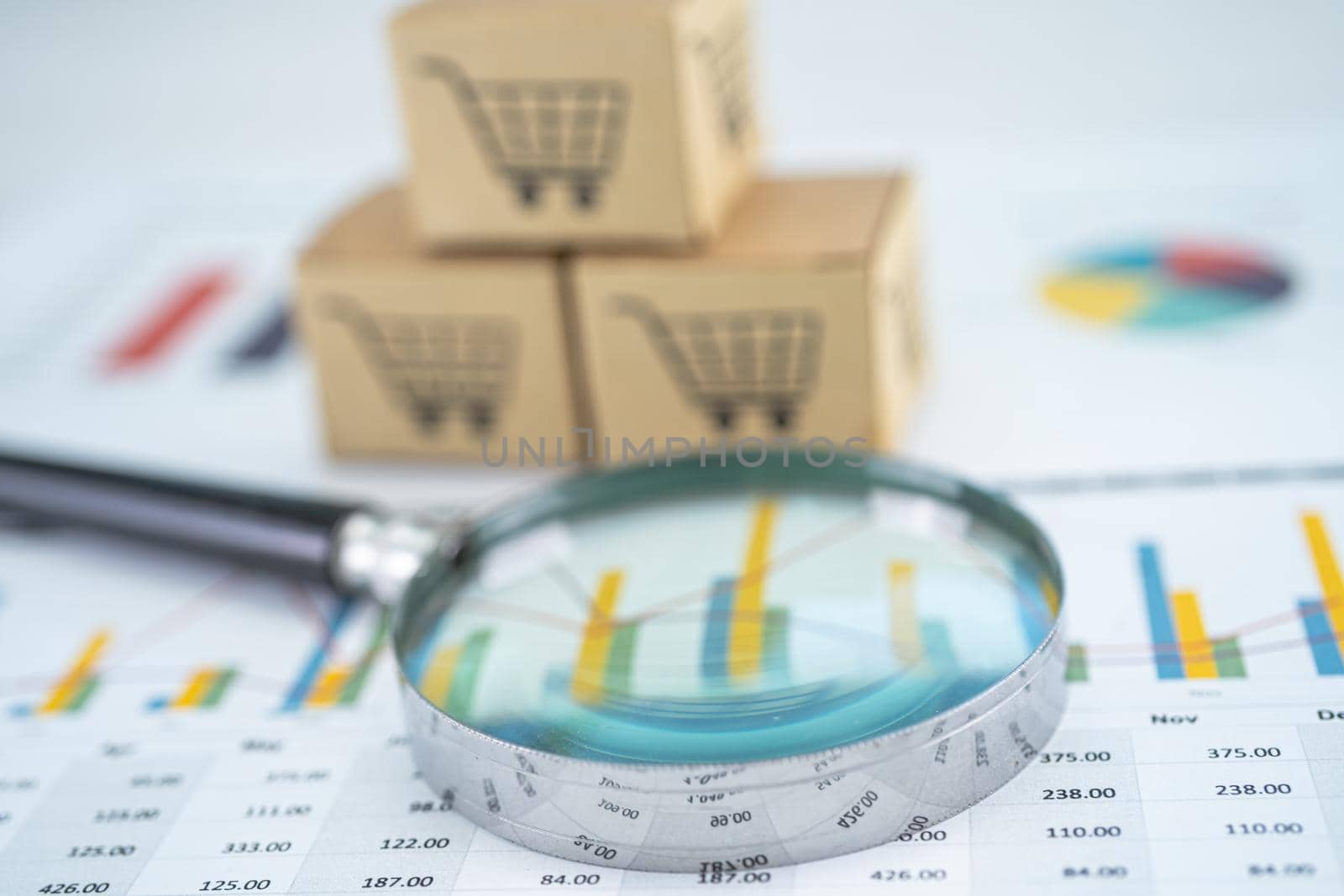 Magnifying glass and shopping cart logo on box with graph background. Banking Account, Investment Analytic research data economy, trading, Business import export transportation online company concept. by pamai