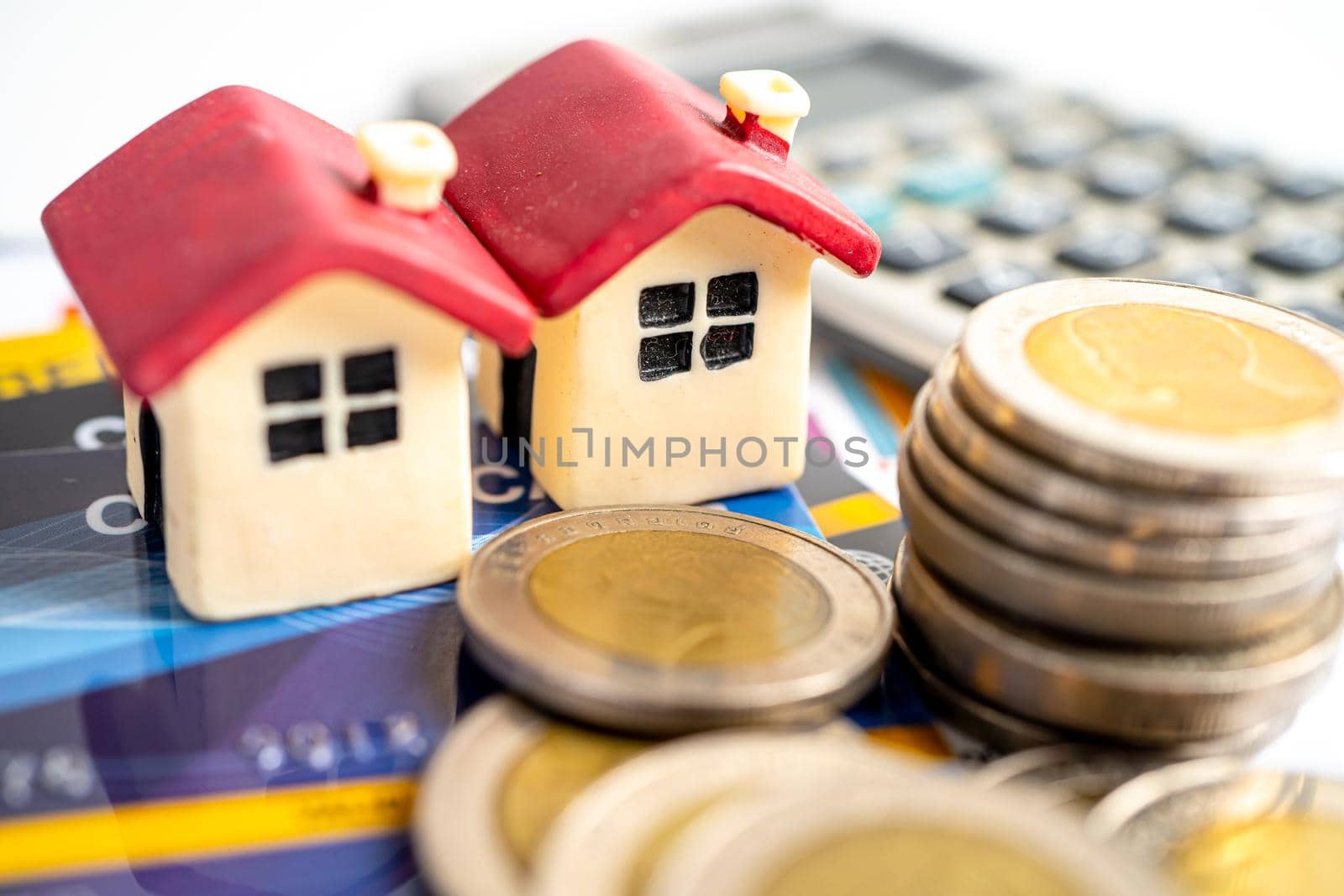 House model on credit card, coin and calculator, installment payment concept. by pamai