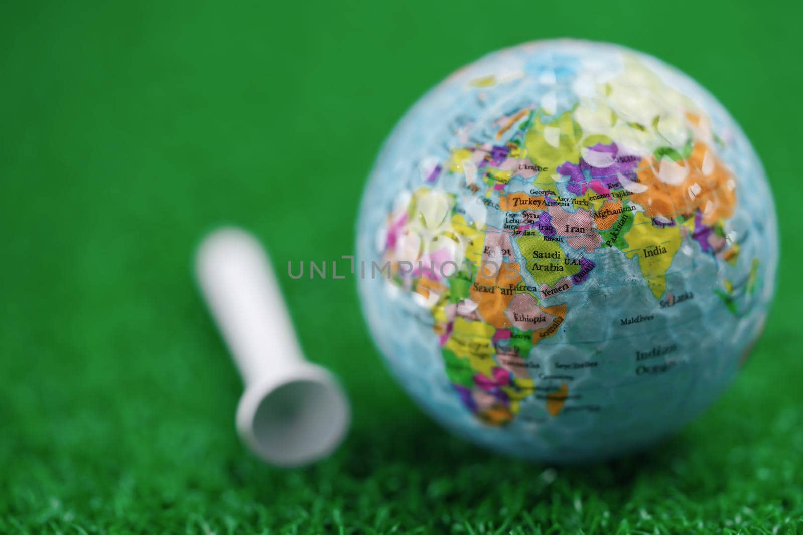 Bangkok, Thailand, July 1, 2020 World globe map at golf ball with on green lawn or field. by pamai