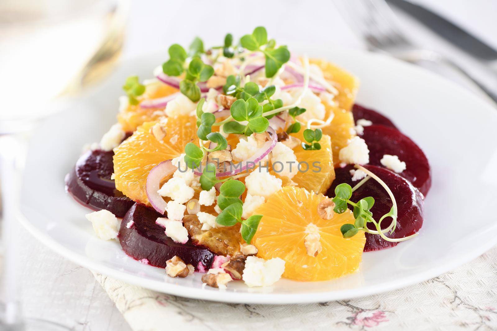 Orange salad with baked beetroot, goat cheese, microgreens and nuts. Perfect as a side dish or as a light lunch for a brunch or dinner.