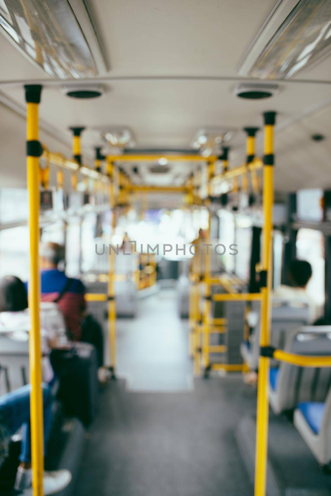 Public transportation. Blur image of interior of modern city bus by makidotvn