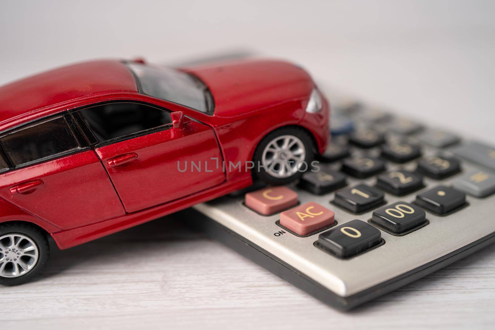 Car on calculator, Car loan, Finance, saving money, insurance and leasing time concepts.