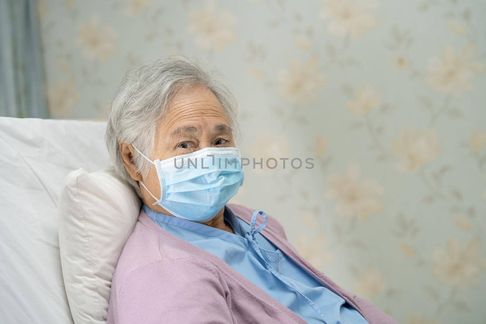 Asian senior or elderly old lady woman patient wearing a face mask new normal in hospital for protect safety infection Covid-19 Coronavirus. by pamai