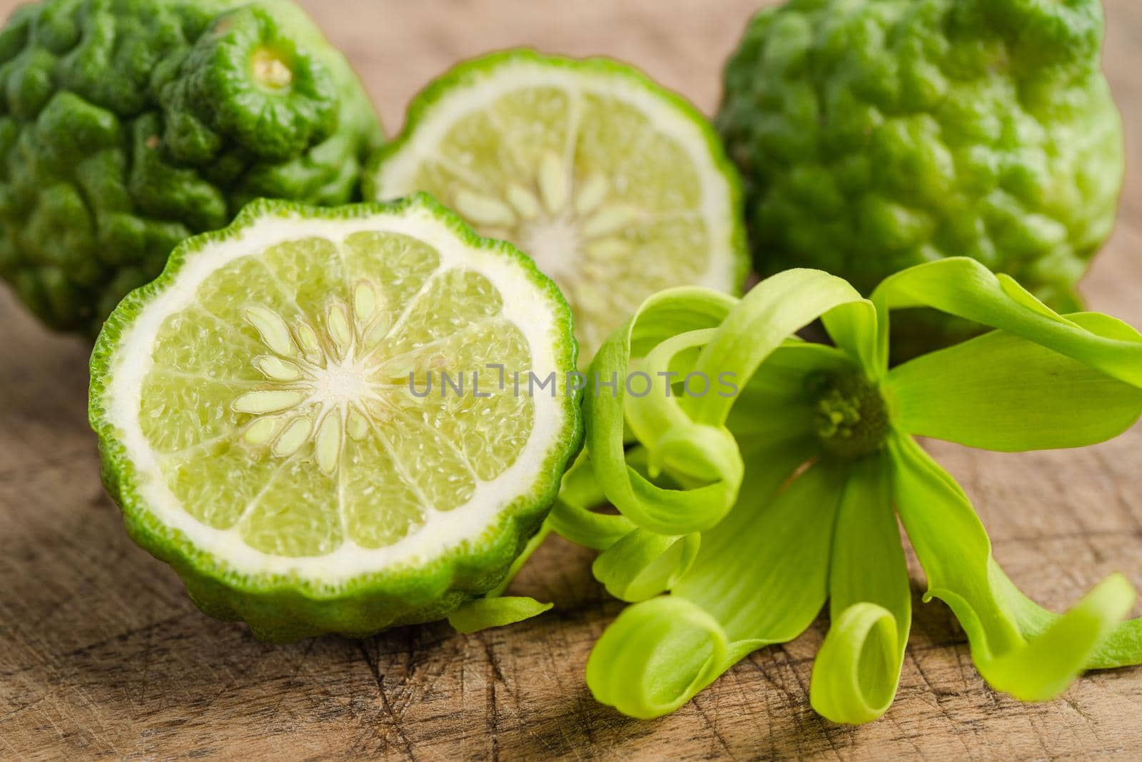 Fresh bergamot fruit with cut in half on wooden background.