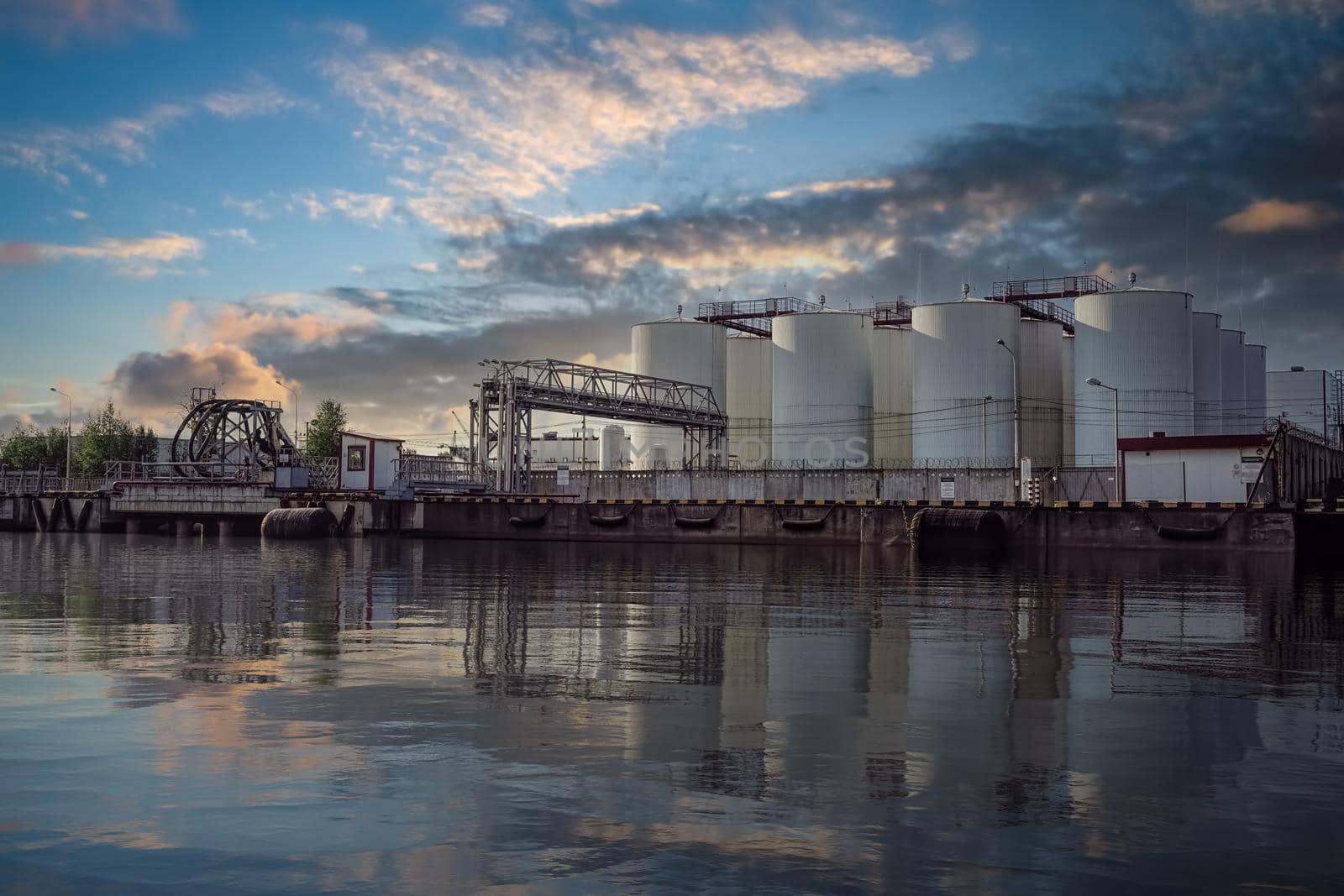 Industrial landscape with a view of a refinery for processing petroleum products by Vvicca