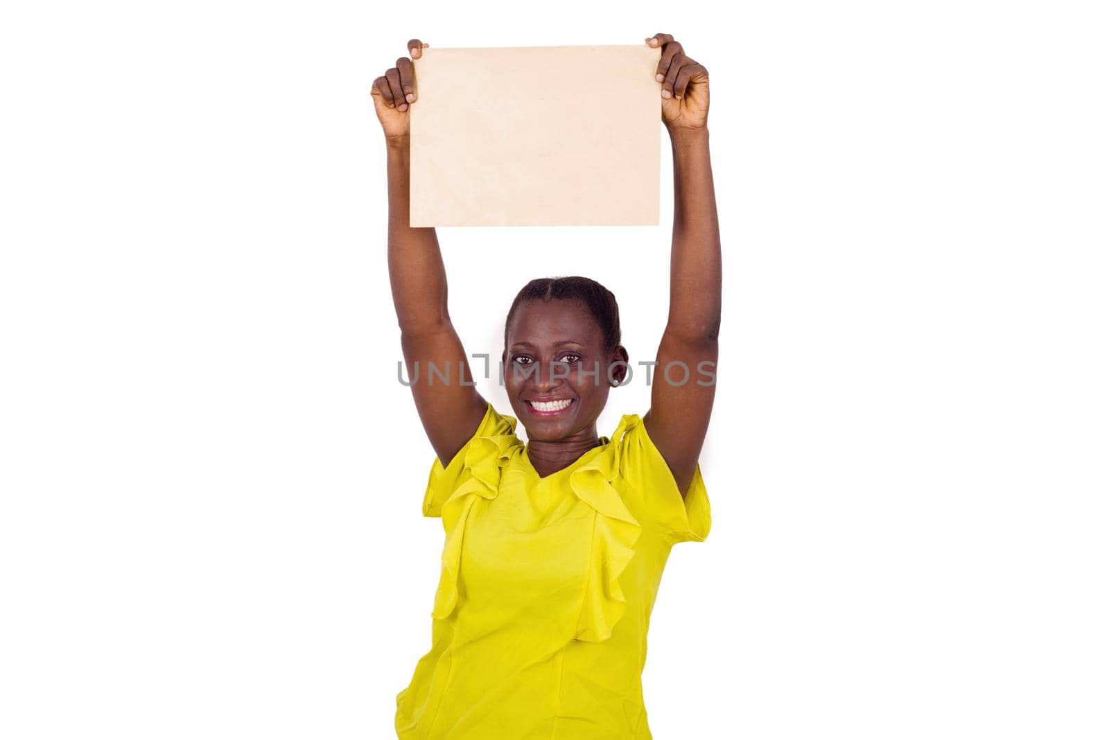 Smiling woman showing a blank sheet of paper with copy space for advertising on white studio background
