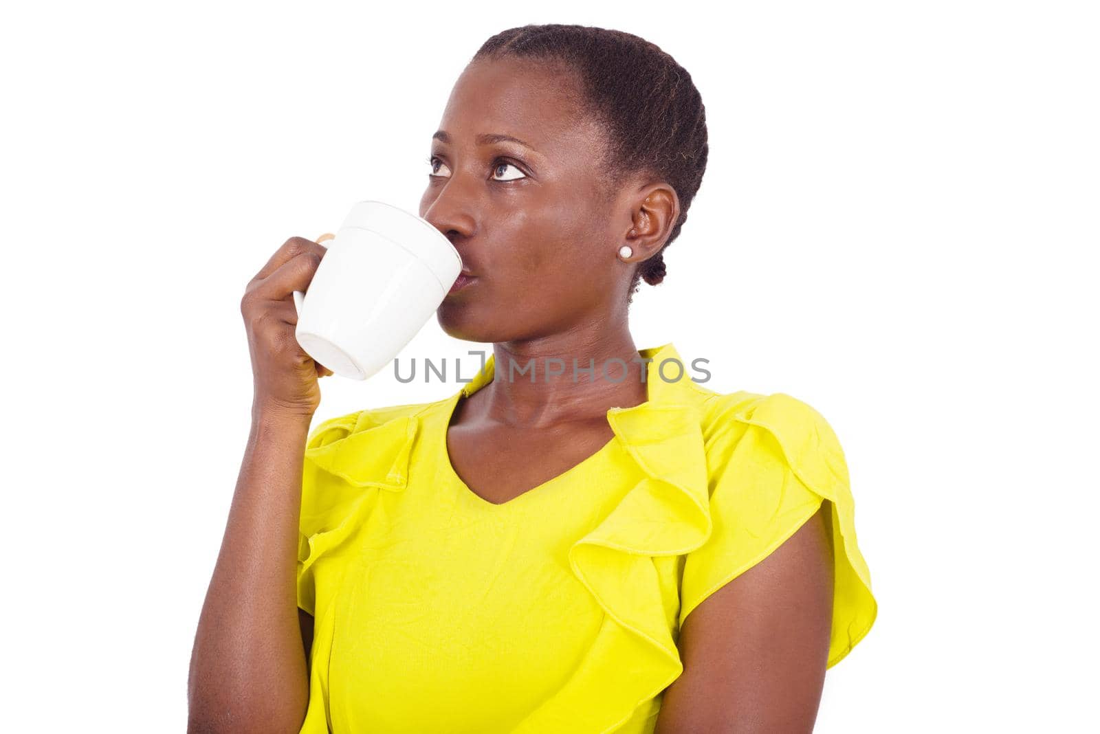 Enjoying fresh coffee. Beautiful young woman drinking coffee and having her eyes raised in studio