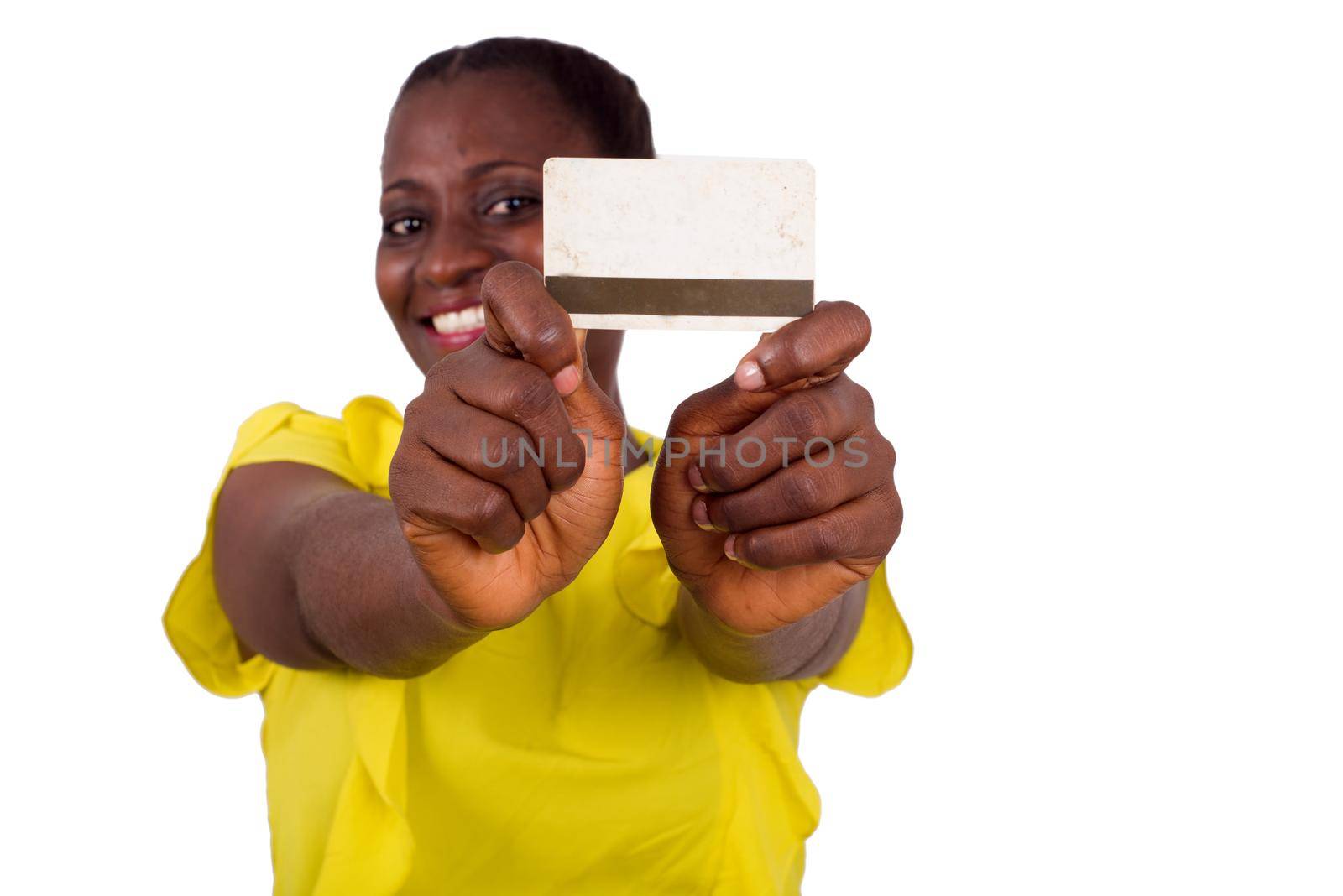 Happy woman standing on white background showing a credit card to the camera