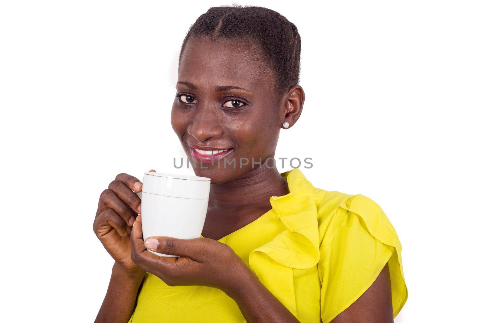 Happy face of young woman drinking coffee indoors.