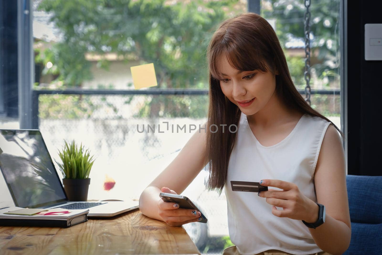Woman enjoy with online shopping application and typing credit card for fill number to payment