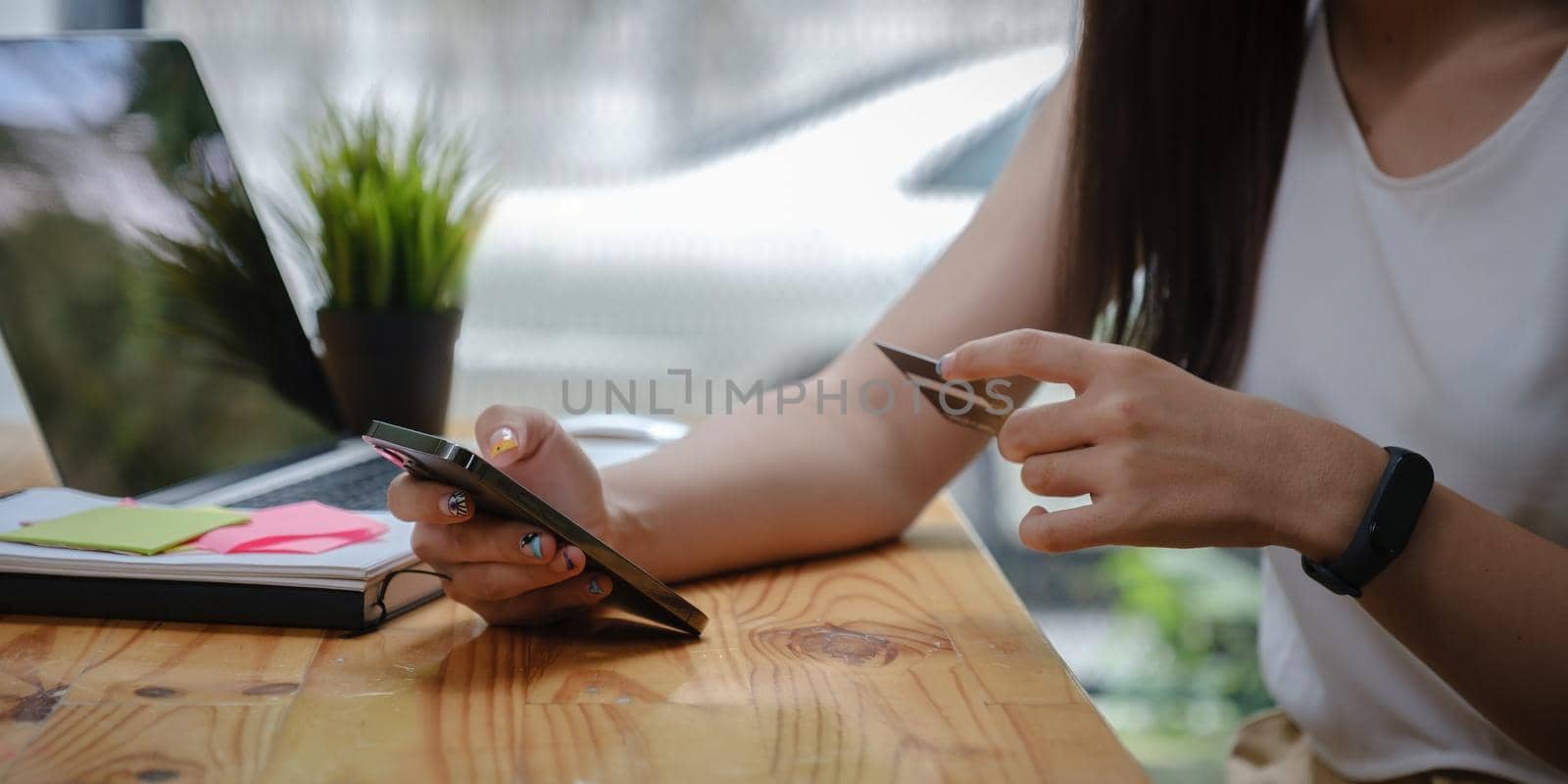 Woman enjoy with online shopping application and typing credit card for fill number to payment.