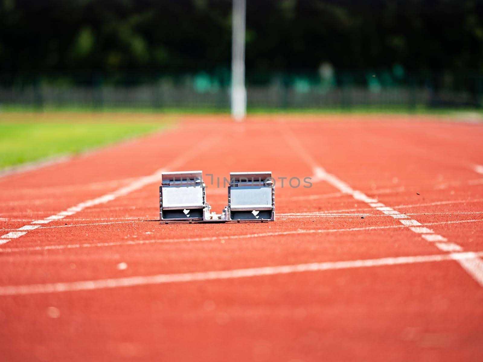 Empty Starting Blocks and red running tracks in a stadion. Athletic training
