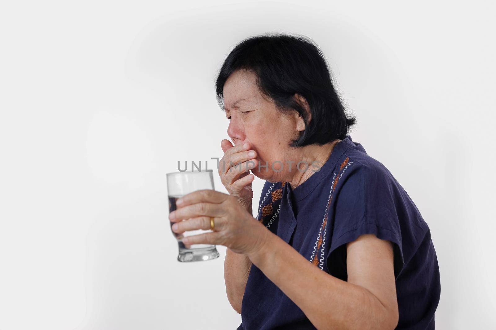 elderly woman Choking a water drink after take  medicine ,isolated on white background. by toa55
