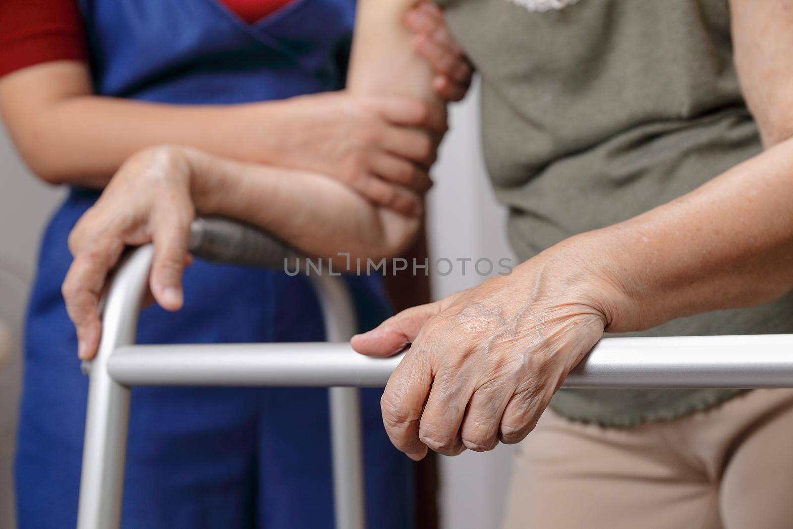 Elderly asian woman using a walker at home with daughter take care