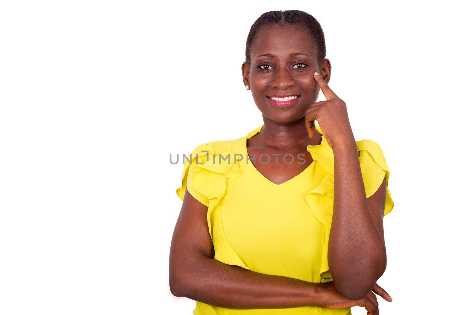 Young woman smiling and standing in studio hand on cheek and looking at camera on white background