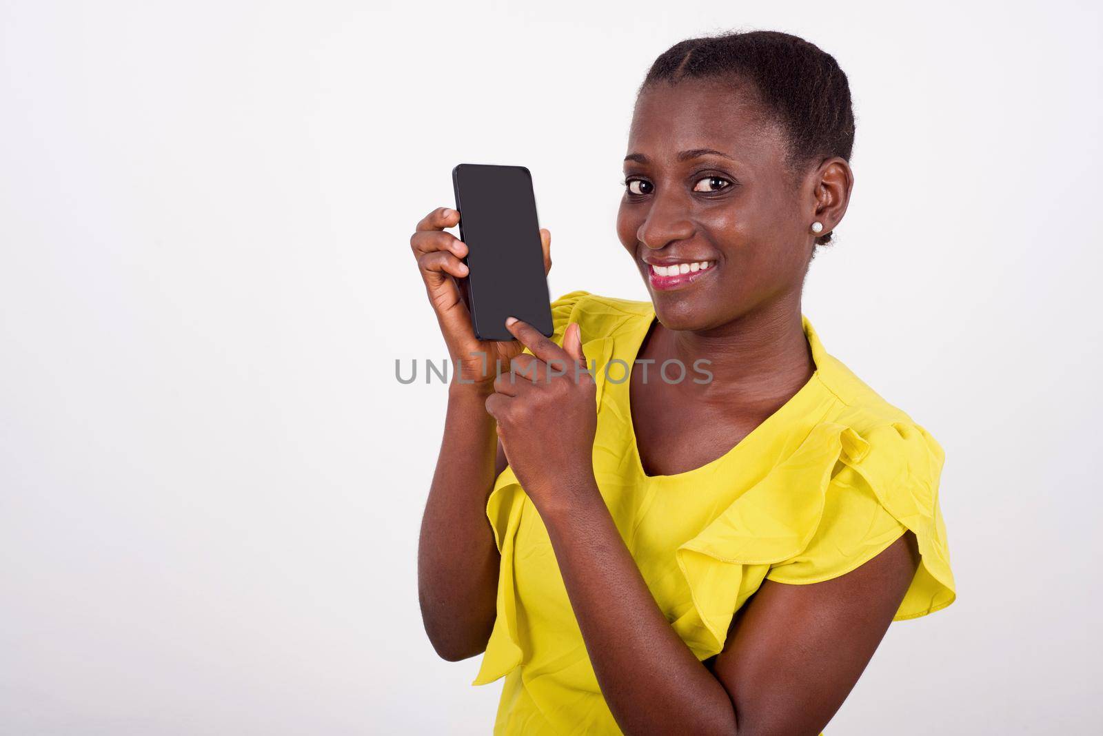 Young smiling and fun woman showing mobile phone display with black screen