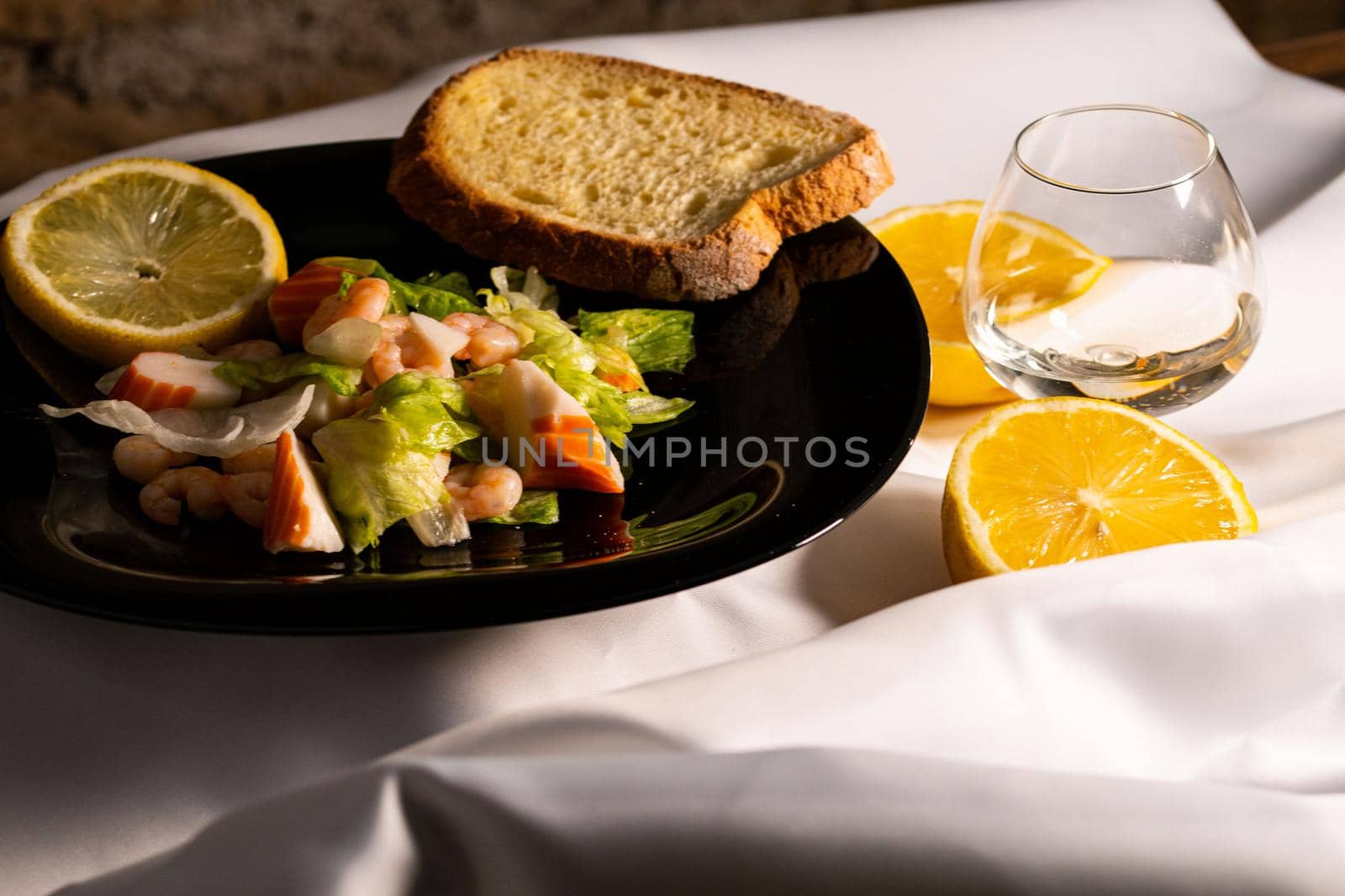 composition of a black plate with shrimp and surimi salad by carfedeph