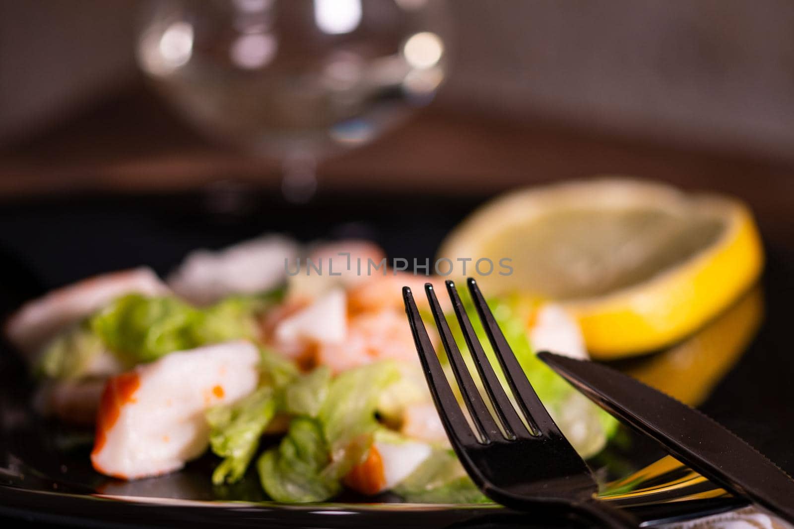 cutlery placed on a plate of fish salad by carfedeph