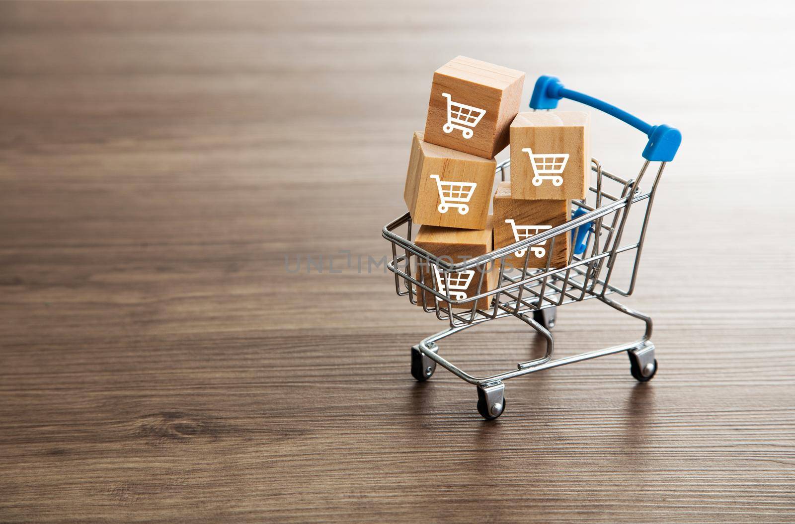 Trolley shopping cart which print screen on wooden cubes block. Shopping Concept