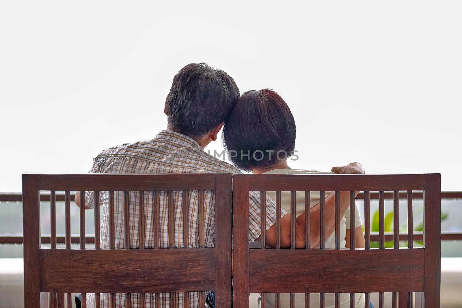 Rear view of a happy asian middle aged a couple on bench by toa55