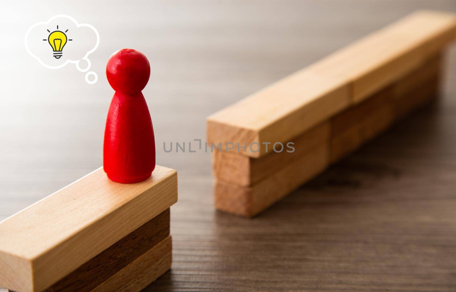 business concept image of challenge. Wooden figure on high wall and needs to be passed to the other side.