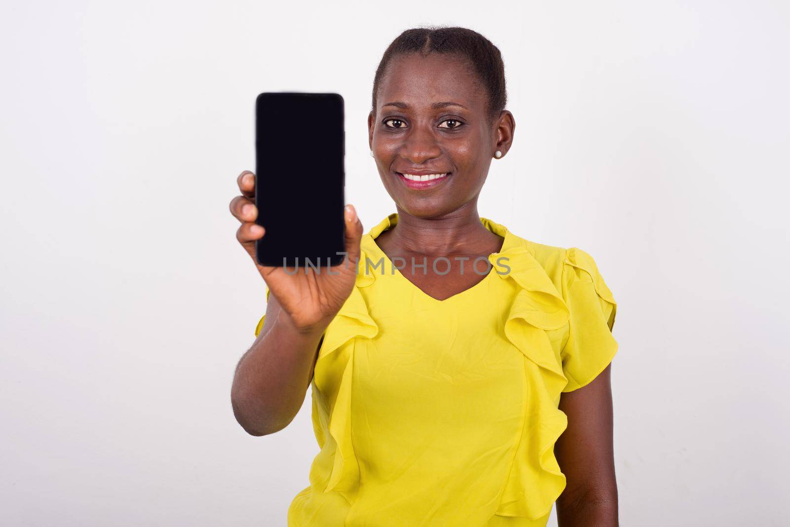 Young smiling and fun woman showing mobile phone display with black screen