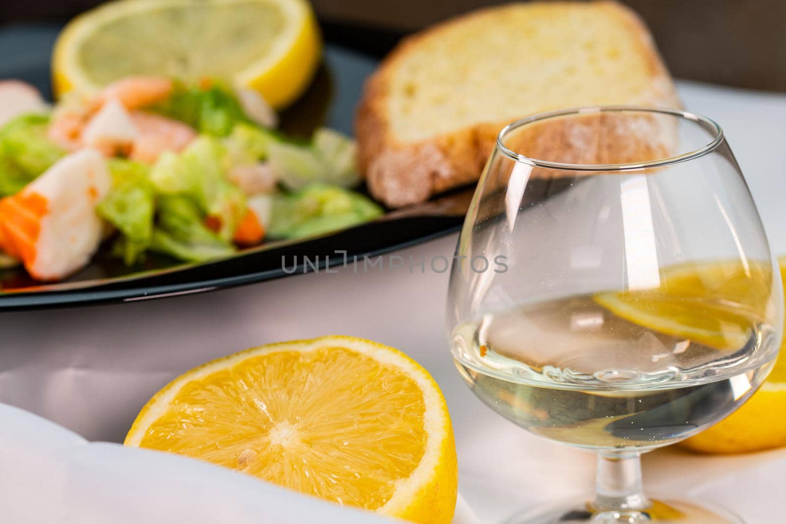 a lemon split in half in front of a fish dish by carfedeph