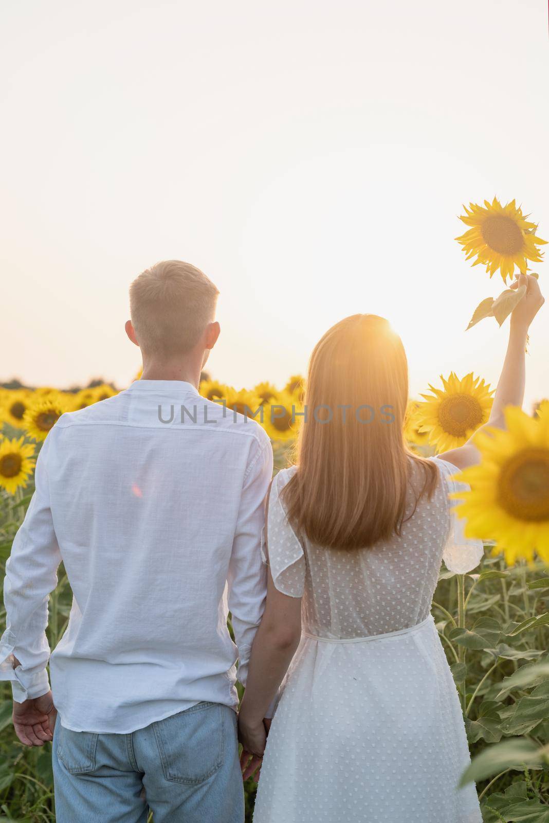 Beautiful couple having fun in sunflowers fields by Desperada