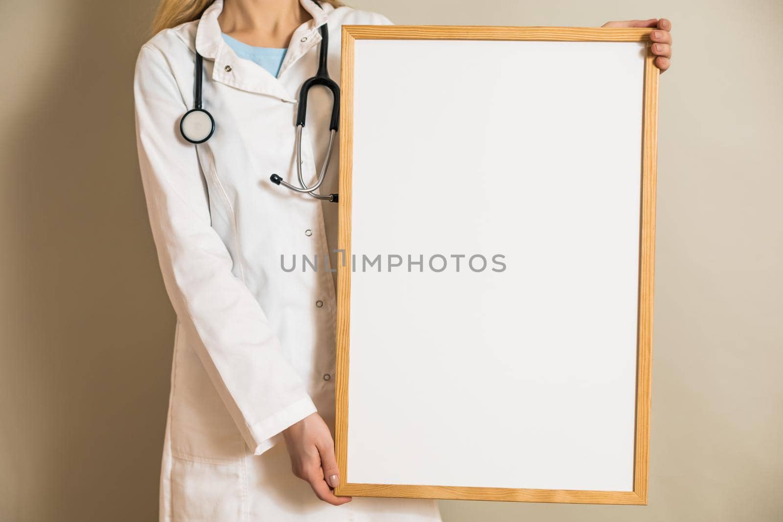 Image of female doctor holding white board.