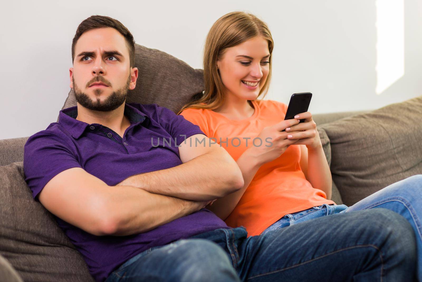 Angry wife and husband are having conflict because wife is using phone too much.