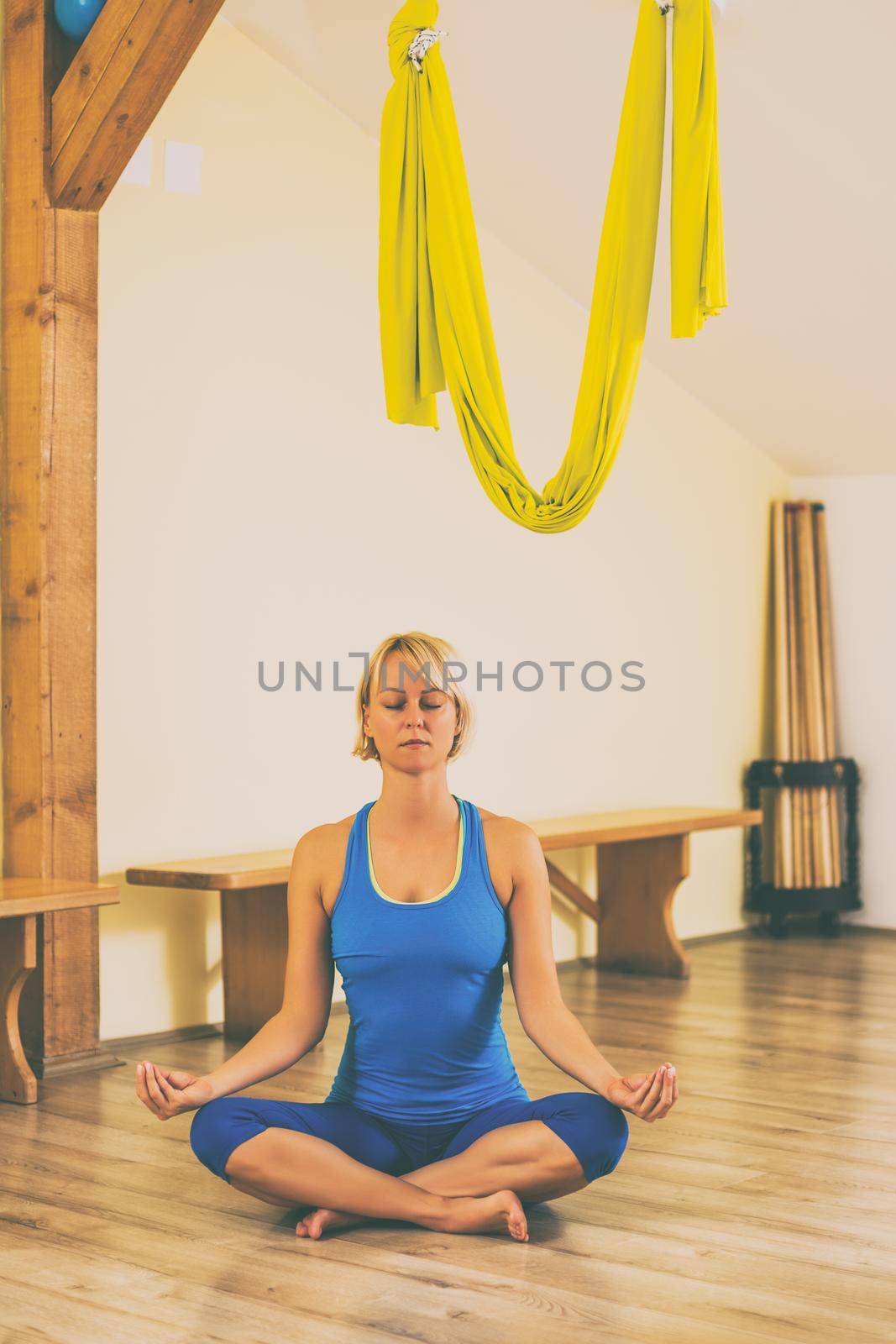 Woman meditating in the fitness studio.Toned image.