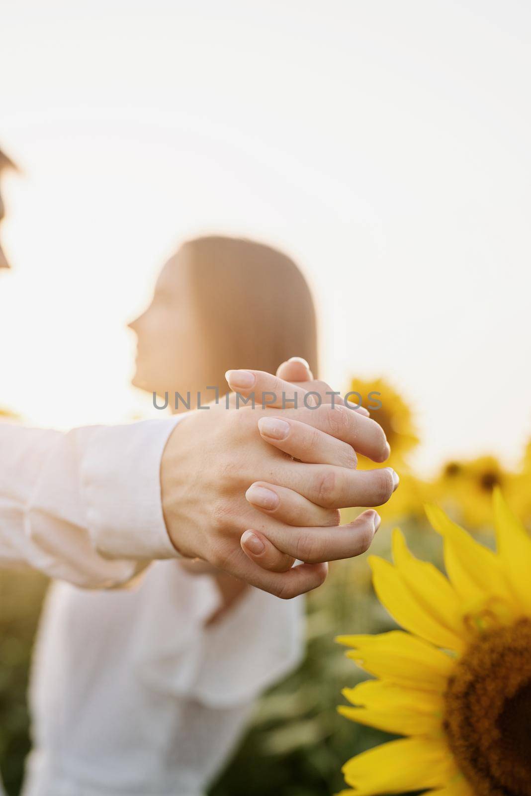 Close up couple holding hands outdoors by Desperada