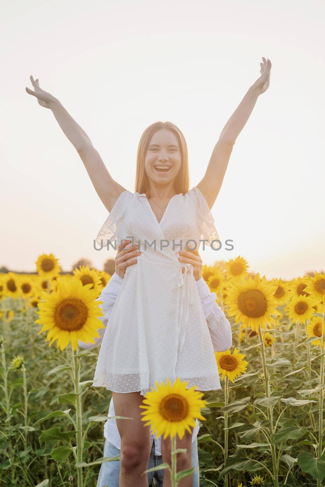 Beautiful couple having fun in sunflowers fields by Desperada