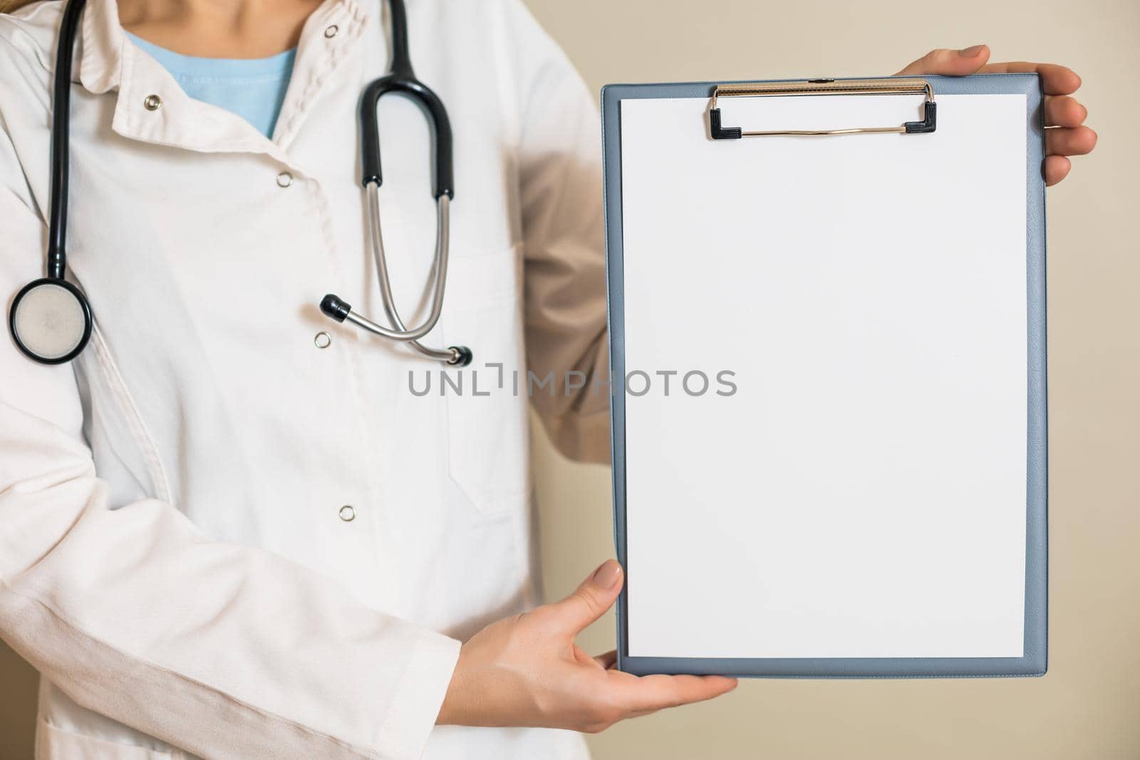 Image of female doctor showing clipboard.