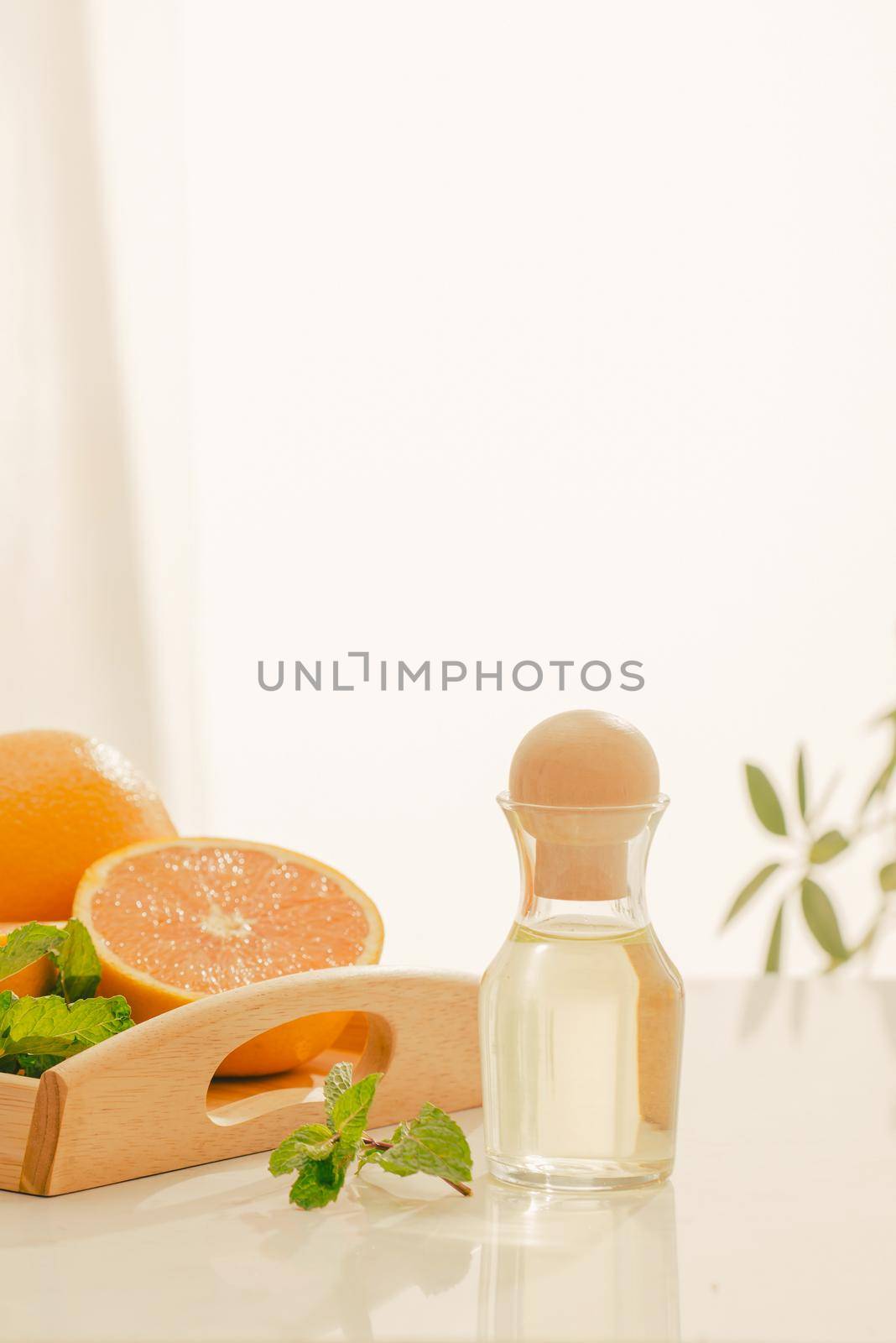 Tangerine oil on table on light background