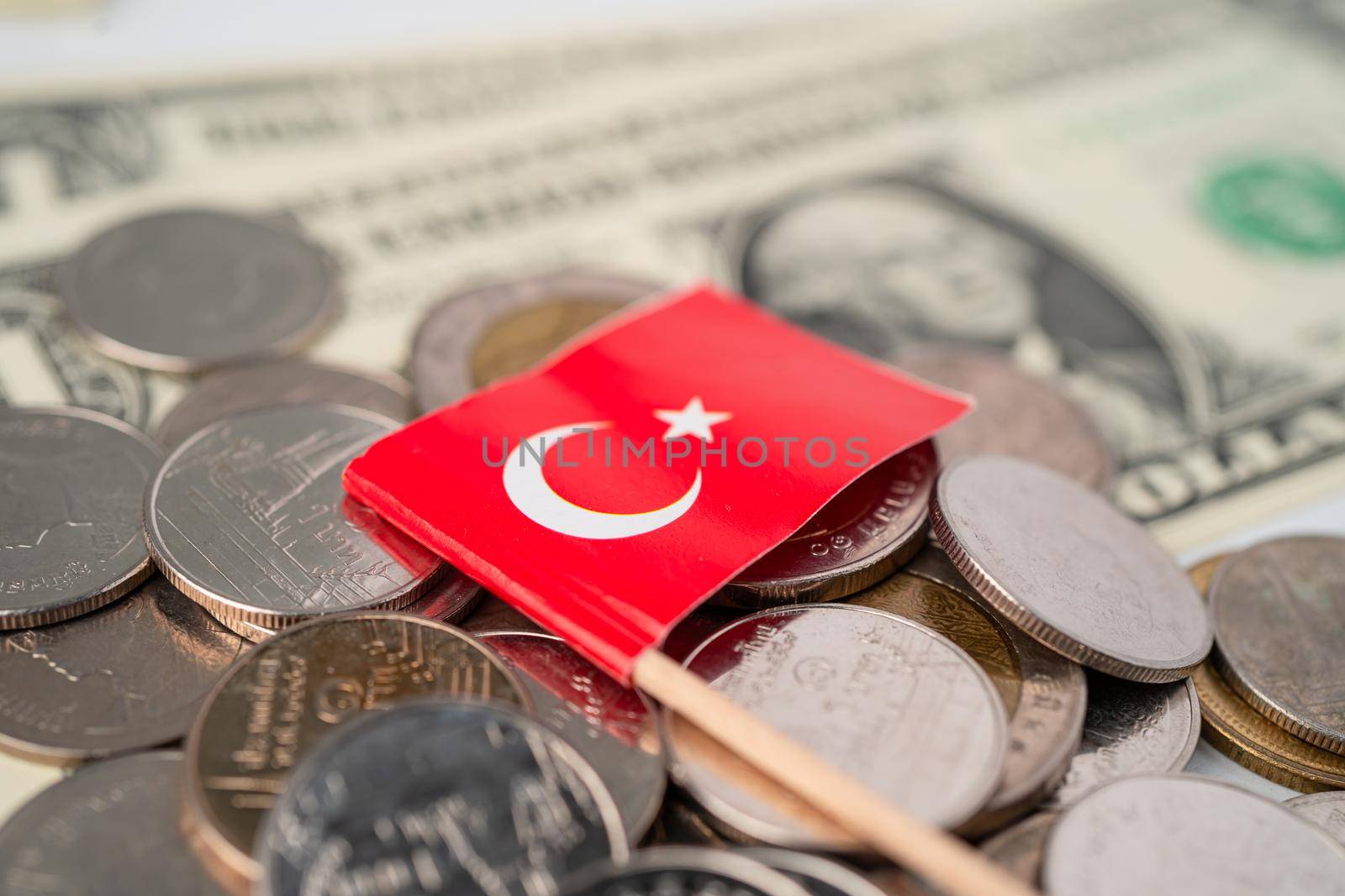 Stack of coins with Turkey flag on USA America dollar banknotes.