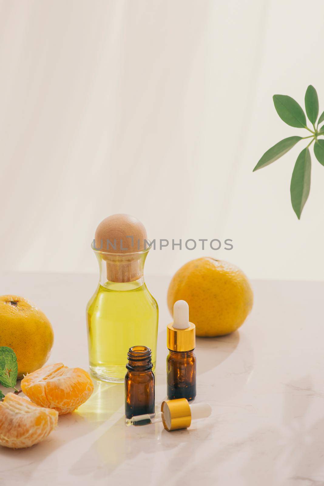 Tangerine oil on table on light background