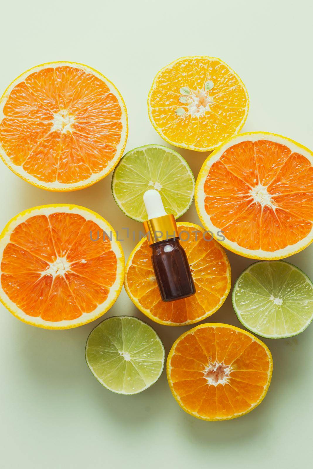 Brown Bottle with lemon, orange, tangerine and vitamin C. on white background.