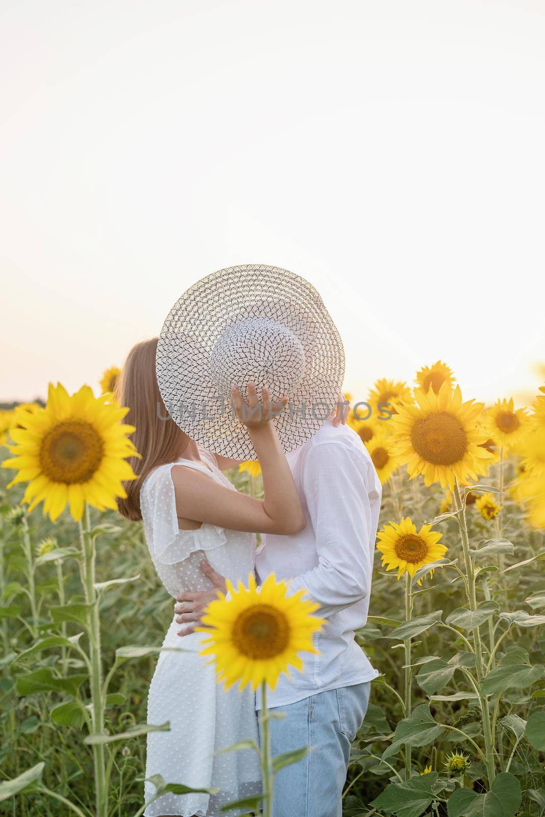 Beautiful couple having fun in sunflowers fields by Desperada