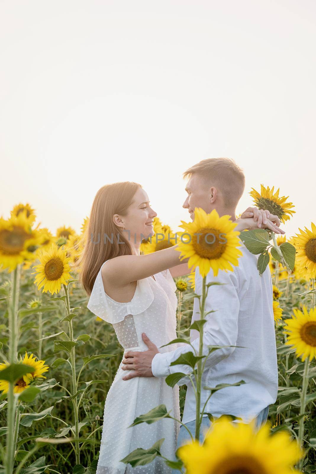 Beautiful couple having fun in sunflowers fields by Desperada