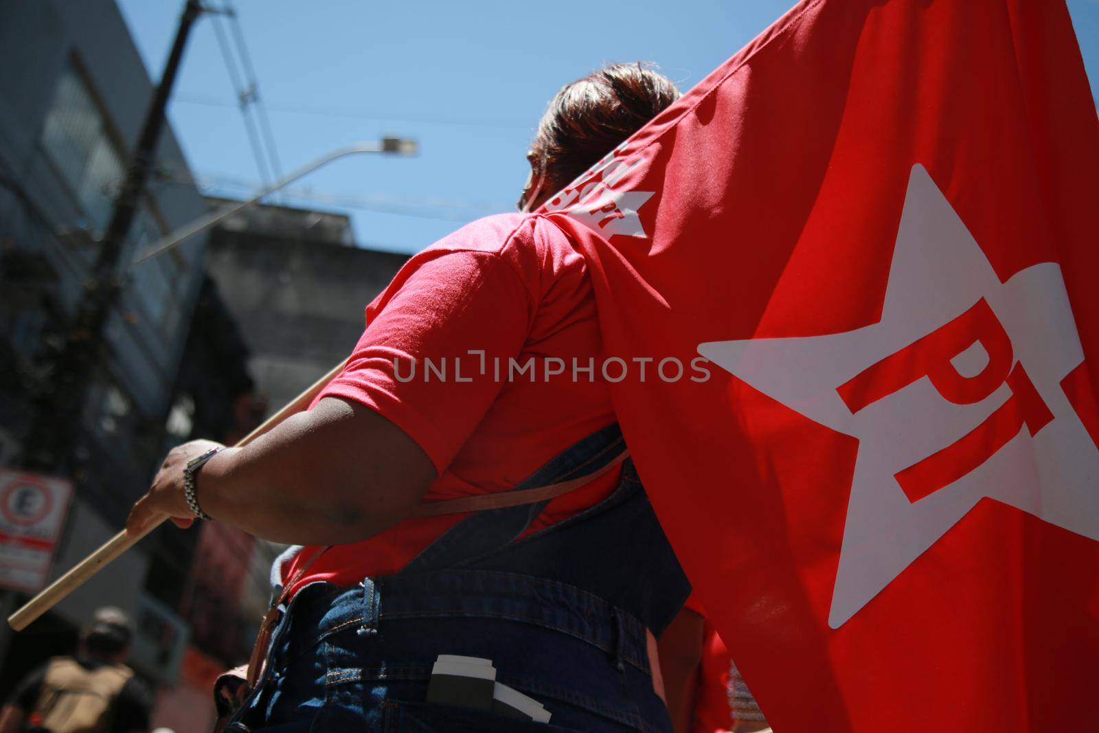 salvador, bahia, brazil - september 7, 2021: protester carries the banner of the Workers Party during a demonstration against President Jair Bolsonaro in the city of Salvador.
