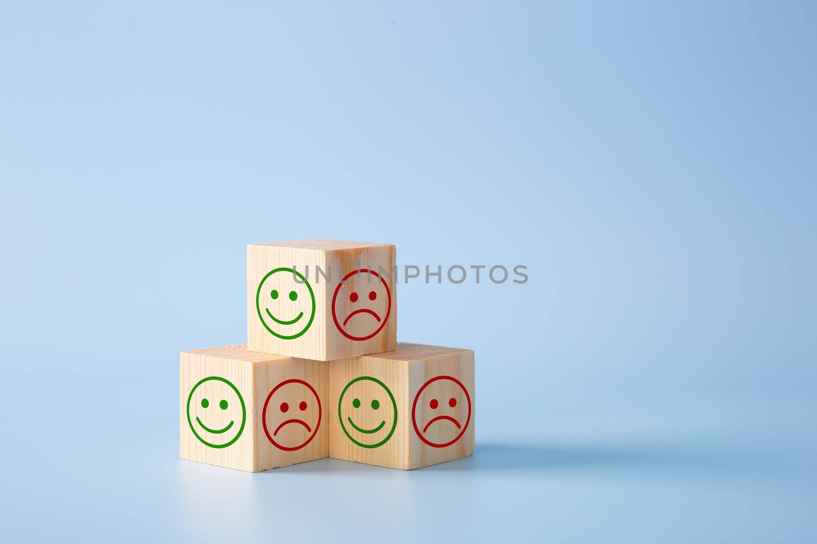 Wooden block With Happy and Unhappy Face. by tehcheesiong