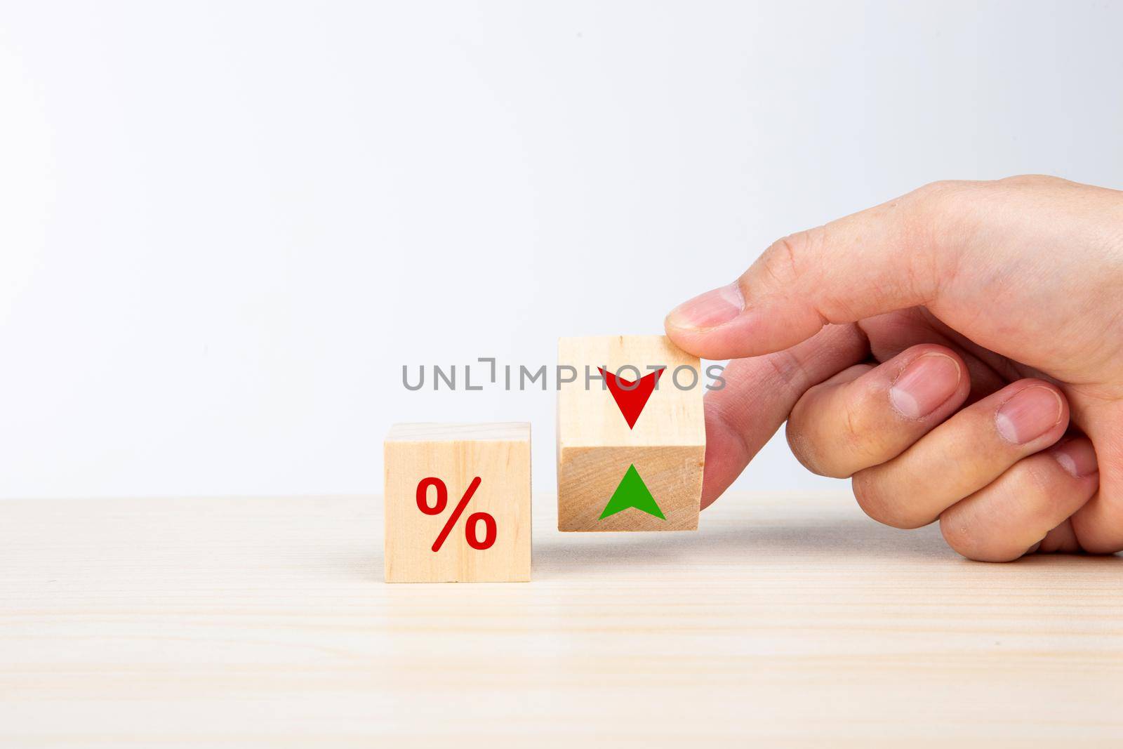 Hand flip wood cube change arrow down to up. Interest rate financial and mortgage rates concept. by tehcheesiong