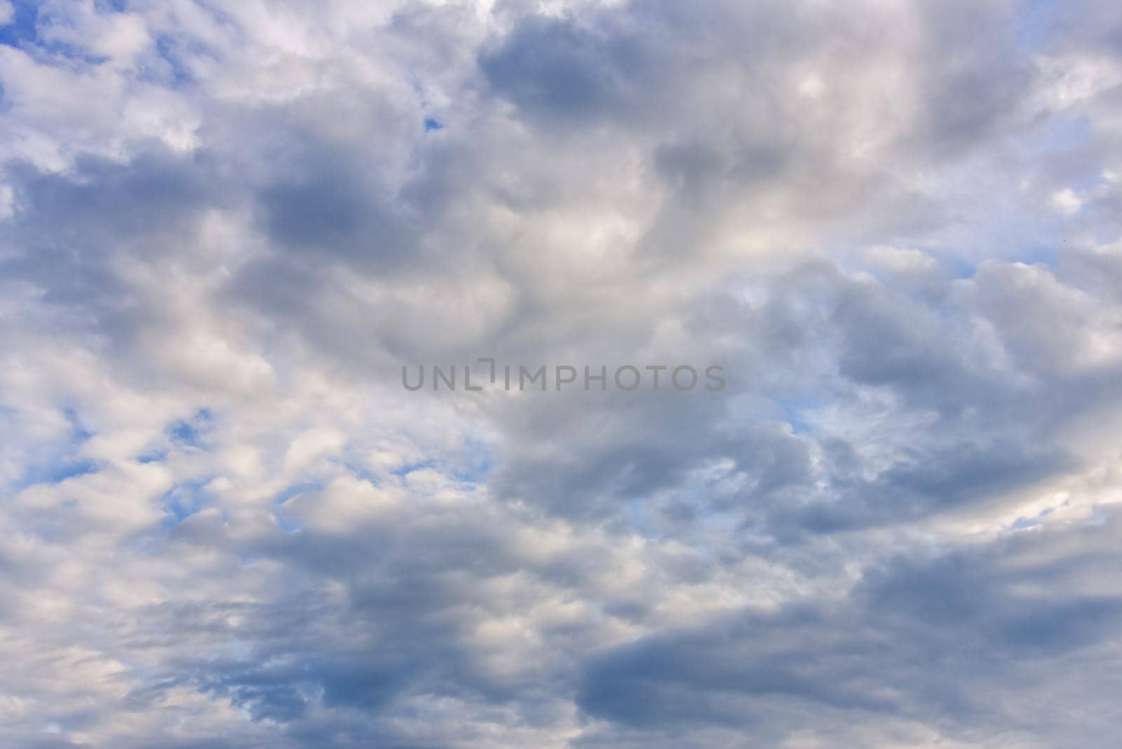 blue sky background with cumulus white clouds.
