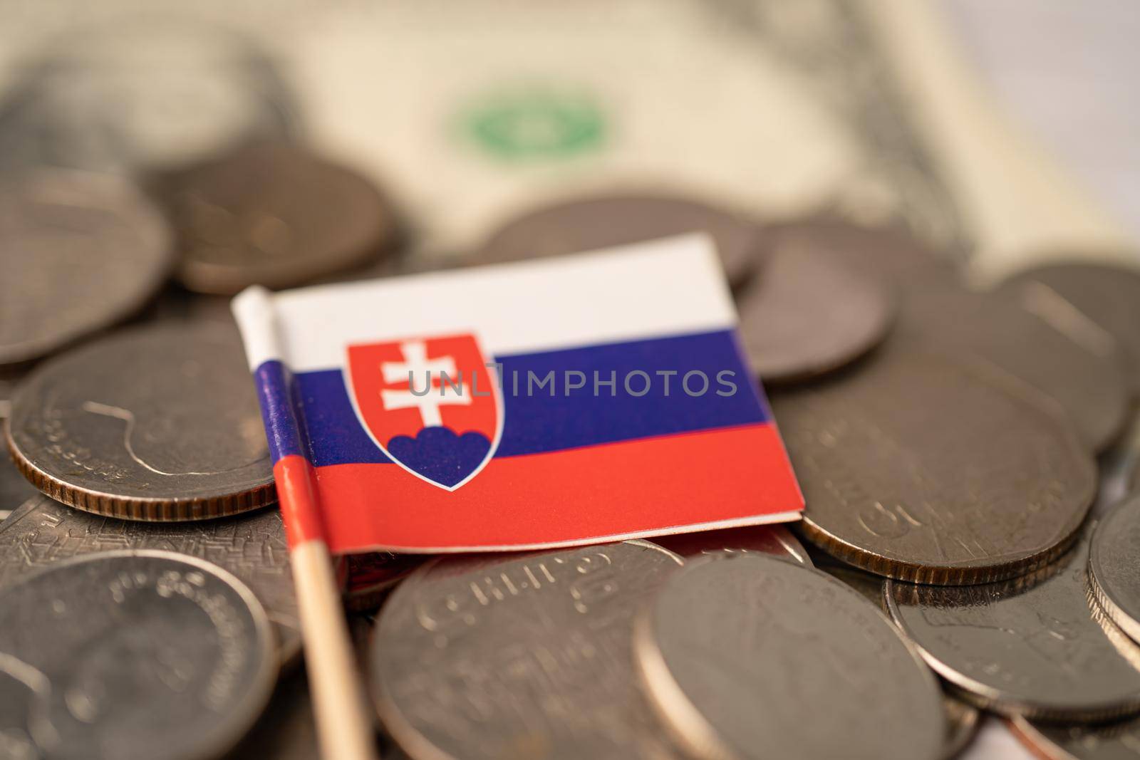 Stack of coins with Slowakia flag on USA America dollar banknotes.