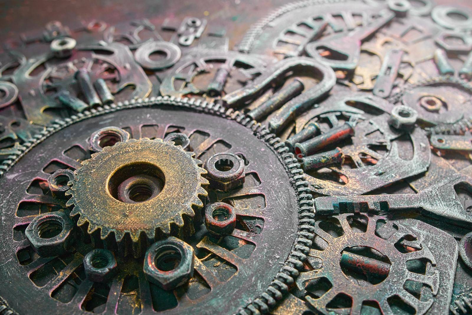 Machine gear, metal cogwheels, nuts and bolts and keys.Gears cogs motion metal industrial background.Selective focus.